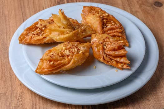 Turkish baklava, sweet dessert with honey on a light plate 13