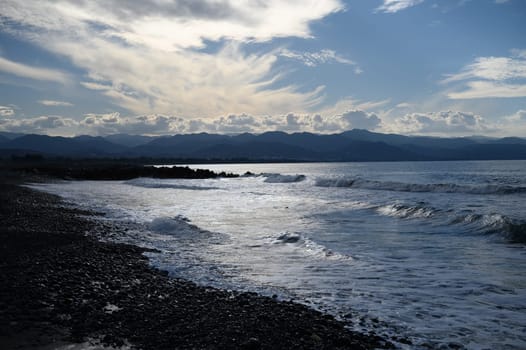 the sun sets behind a mountain on the Mediterranean coast 1