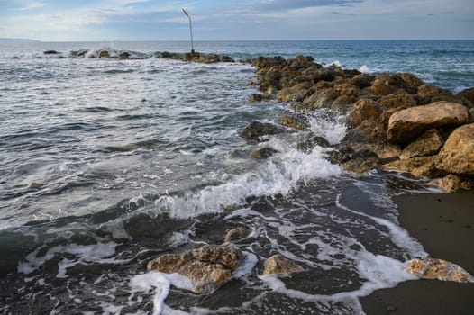 waves crashing on rocks on the Mediterranean coast