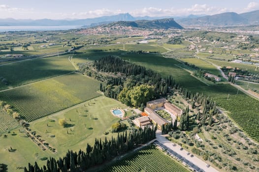 Green fields, forest and swimming pool near Villa Cordevigo. Verona, Italy. Aerial view. High quality photo