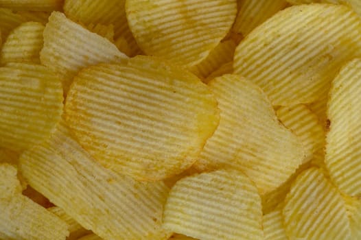 food background, delicious potato chips laid out on the table