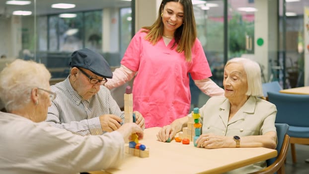 Friendly nurse talking to senior people in the nursing home