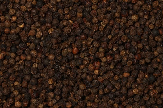 Background of black peppercorns, natural spice condiment pattern texture, elevated top view, directly above