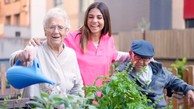 Photo of a nurse and senior people watering plants outdoors a nursing home
