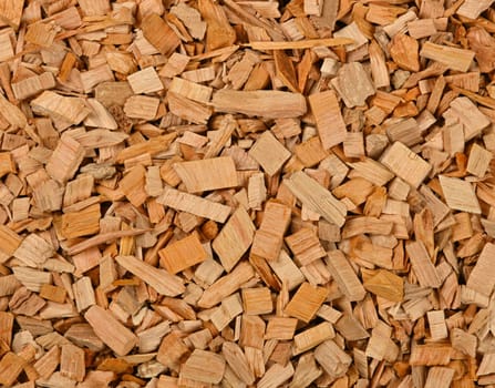 Close up background pattern of hardwood alder chips for food smoking and cooking, elevated top view, directly above