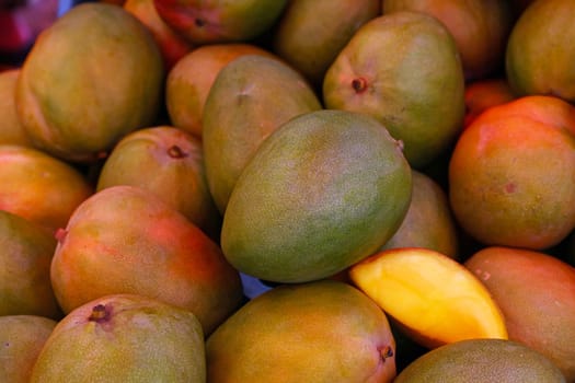 Close up fresh mango fruits on retail display of farmer market, high angle view