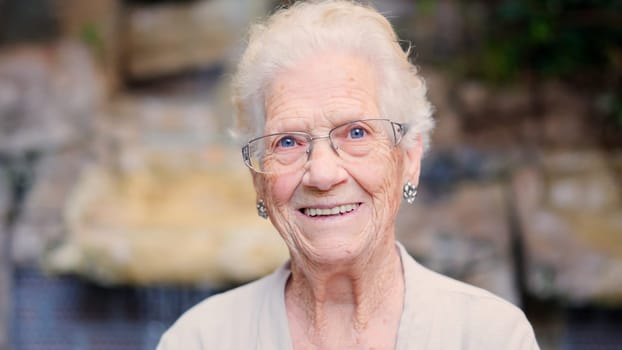 Portrait of a happy grandmother smiling at camera at home