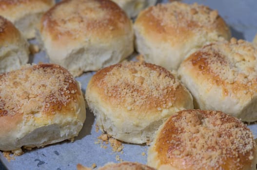 homemade bread rolls on parchment on a baking sheet 6