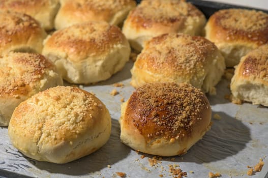 homemade bread rolls on parchment on a baking sheet 4