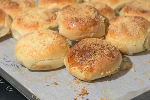 homemade bread rolls on parchment on a baking sheet 2