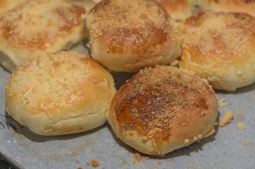 homemade bread rolls on parchment on a baking sheet 1