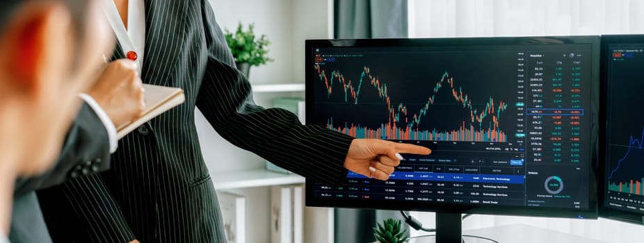 Group of profession trader discuss about stock market investment while point the increasing financial graph displayed on computer. Stock market investment concept Cropped image. Burgeoning.