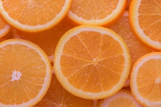 oranges cut into slices and laid out on the table as a food background 11