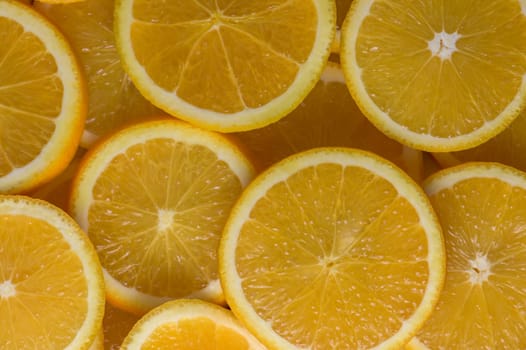 oranges cut into slices and laid out on the table as a food background