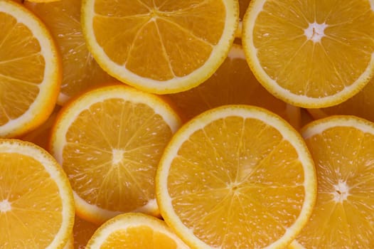 oranges cut into slices and laid out on the table as a food background 14
