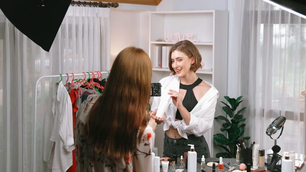 Two influencer partner shoot live streaming vlog video review makeup prim social media or blog. Happy young girl with cosmetics studio lighting for marketing recording session broadcasting online.