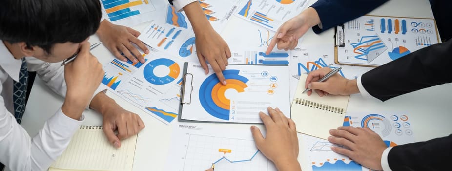 Business people in group meeting in formal attire share idea discussing report for company profit in creative workspace for start up business shot in close up view on group meeting table . Oratory .