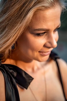 Blonde long hair, nature summer happy adult girl with long blond hair developing in the wind in nature. Dressed in a black top, white skirt