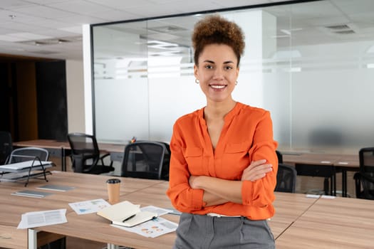 Smiling businesswoman using her phone in the office.