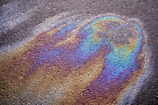 Fuel or oil stain on an asphalt road as a texture or background.