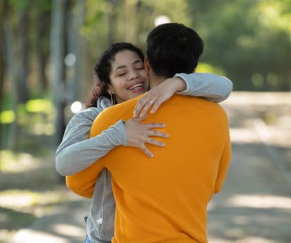 Latin couple hugging with affection and love in a park.