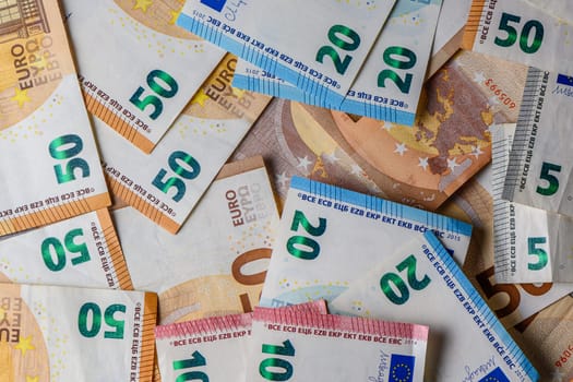 euro bills scattered on the table as a background 16