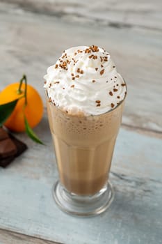 Orange and chocolate milkshake with coffee sprinkled on top