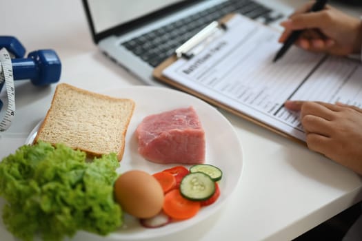 Nutritious food with fresh vegetable, meat and egg for healthy diet on white table.