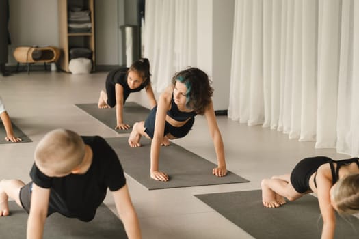 Children do Yoga in the fitness room. Children's gymnastics.