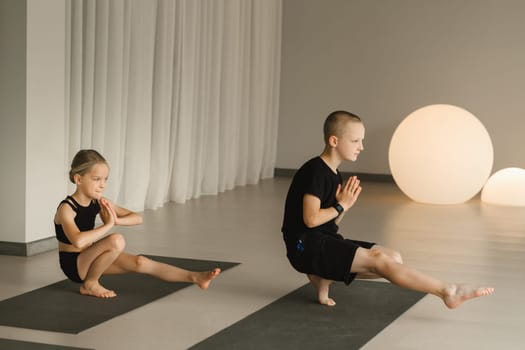 Children do Yoga in the fitness room. Children's gymnastics.