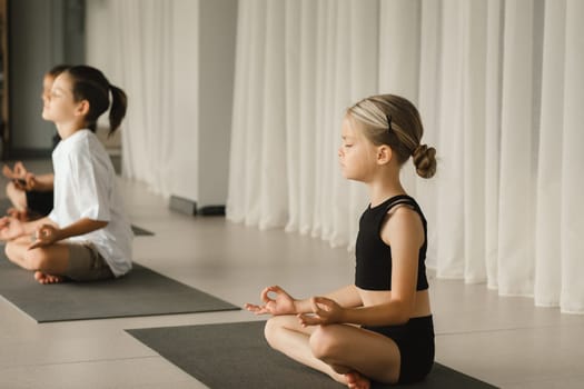 Children do Yoga in the fitness room. Children's gymnastics..