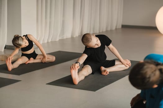 Children do Yoga in the fitness room. Children's gymnastics.