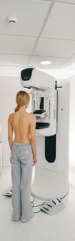 Woman doing mammogram x ray for breast cancer prevention screening at hospital. High quality photo