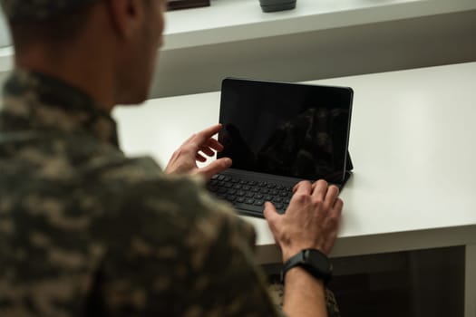 Caucasian soldier in army uniform in front of computer feeling happy and excited. American soldier receiving good news. High quality photo