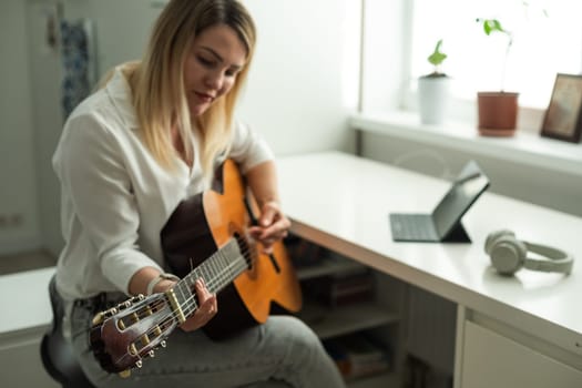 woman holding a guitar with her hands. High quality photo