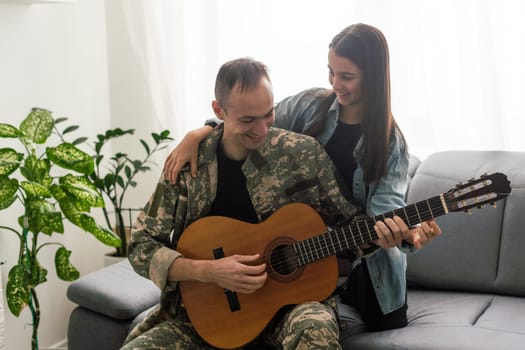 a veteran and his daughter play the guitar. High quality