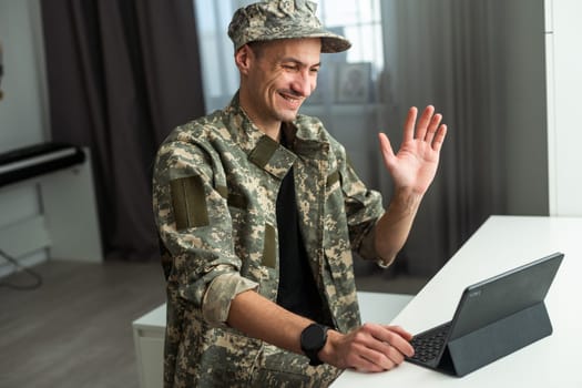 Caucasian soldier in army uniform in front of computer feeling happy and excited. American soldier receiving good news. High quality photo