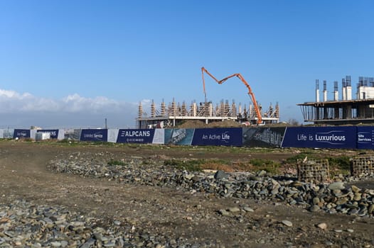 machine for pouring concrete at the construction site of a new complex near the sea 11