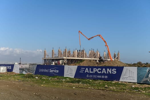 machine for pouring concrete at the construction site of a new complex near the sea