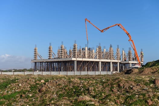 machine for pouring concrete at the construction site of a new complex near the sea 6