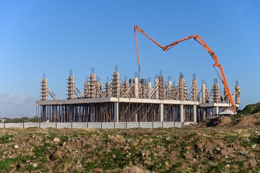 machine for pouring concrete at the construction site of a new complex near the sea 5