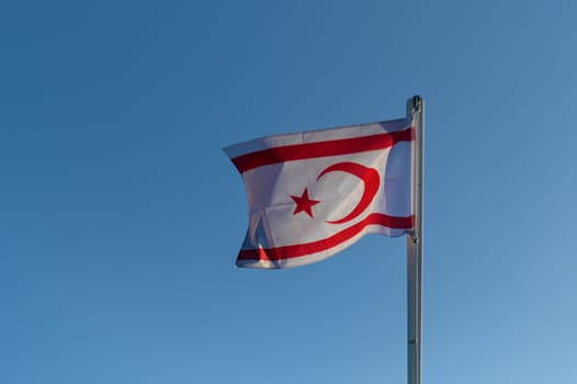 flag of the Turkish Republic of Northern Cyprus against the blue sky