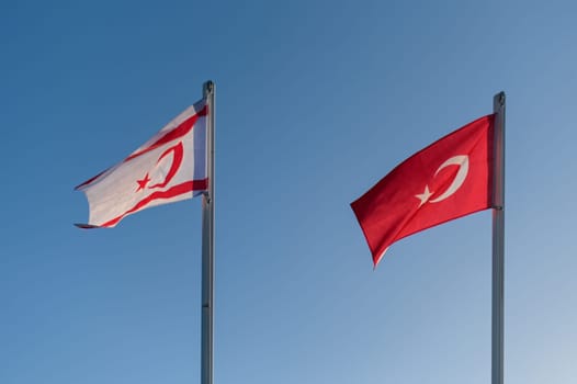 flags of the Turkish Republic of Northern Cyprus and Turkey against the blue sky 2