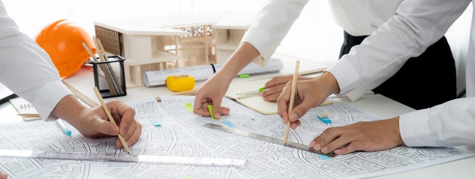 Worker, architect and engineer work on real estate construction project oratory planning with cartography and cadastral map of urban town area to guide to construction developer business plan of city