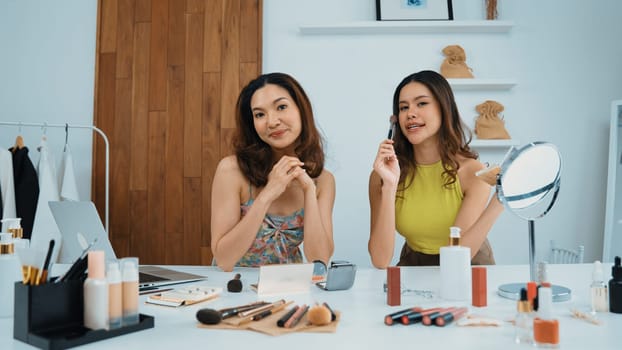 Two influencer partner shoot live streaming vlog video review makeup social media or blog. Happy young girl with vivancy cosmetics studio lighting for marketing recording session broadcasting online.