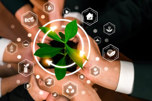 Business partnership nurturing or growing plant together with carbon icon symbolize ESG sustainable environment protection with eco technology and carbon credit solution for net zero future. Reliance