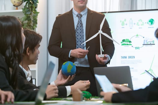 Businessman leader give presentation on eco-friendly implementation in order to reduce CO2 emission and make sustainable ecology for greener future with renewable alternative energy technology. Quaint