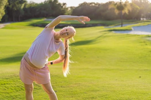 Energetic pregnant woman takes her workout outdoors, using an exercise mat for a refreshing and health-conscious outdoor exercise session.