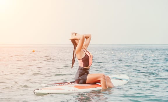 Sea woman sup. Silhouette of happy young woman in pink bikini, surfing on SUP board, confident paddling through water surface. Idyllic sunset. Active lifestyle at sea or river. Slow motion