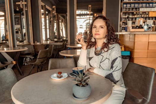 Woman cafe coffee breakfast. Portrait of an adult beautiful woman in an elegant suit in a cafe.